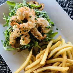 John's Cafe - Shrimp Scampi Toast - faintly seasoned with garlic, white wine, and lemon -- on toasted garlic bread topped with arugula