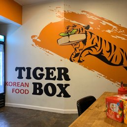 a tiger on the wall of a korean food restaurant