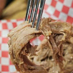 Due South BBQ - Close-up of a fork holding a piece of the moist and juicy Pulled Pork.