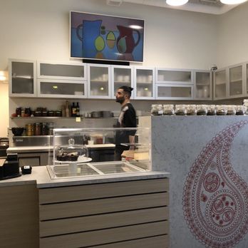 Botte Chai Bar - a man preparing food in a kitchen - Tea Rooms Near Me - Saskatoon, Saskatchewan