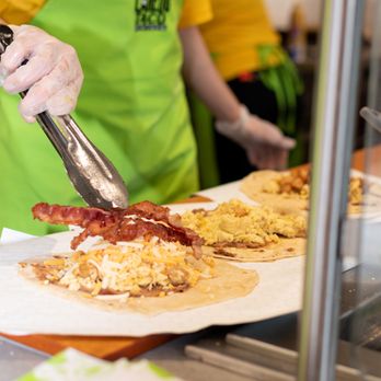 Laredo Taco Company - a person preparing food - Tacos Near Me - Richmond, Texas Laredo Taco Company - a person preparing food - Tacos Near Me - Richmond, Texas