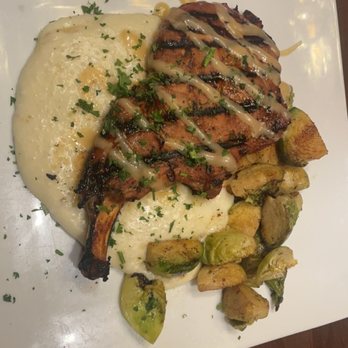 River Rouge Kitchen & Bar - Grilled pork-chop and pepper jack grits. - Wine Bars Near Me - Baton Rouge, Louisiana River Rouge Kitchen & Bar - Grilled pork-chop and pepper jack grits. - Wine Bars Near Me - Baton Rouge, Louisiana