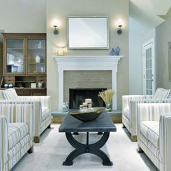 Barbara Feldman Interiors - Transitional Living Room Southampton NY with striped chairs as seating group, metal dining table and fireplace