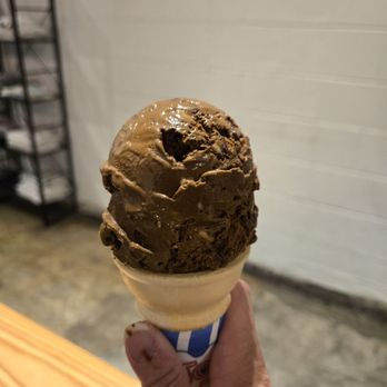 Two Roosters Ice Cream - Dark chocolate mint chip in a cake cone (haha ice cream on my thumb) - Ice Cream & Frozen Yogurt Near Me - Raleigh, North Carolina