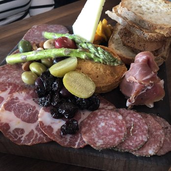 Postino Heights - Butcher's Block - assortment of artisan meats and cheeses, smoked almond hummus, asparagus, olives, nuts and crostini - Wine Bars Near Me - Houston, Texas Postino Heights - Butcher's Block - assortment of artisan meats and cheeses, smoked almond hummus, asparagus, olives, nuts and crostini - Wine Bars Near Me - Houston, Texas