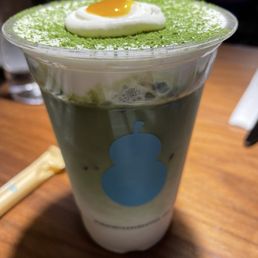 Matcha latte with egg gummy on top Matcha latte with egg gummy on top