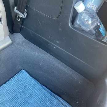 Auto Pride - the interior of a car with a blue towel and a bottle of water - Car Wash Near Me - Burlingame, California