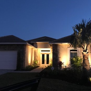 Dragonfly Landscapes - the front of a home at night - Landscaping Near Me - Vero Beach, Florida Dragonfly Landscapes - the front of a home at night - Landscaping Near Me - Vero Beach, Florida