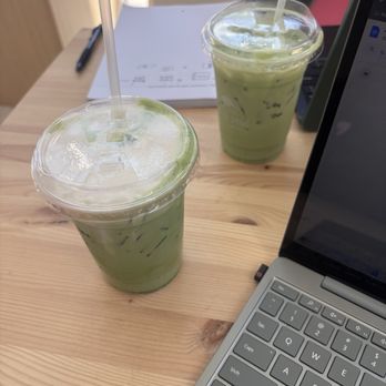 Stray Dogs Coffee Roasters - Melona matcha - seasonal (closest to camera) Matcha with added syrup (furthest from camera) - Coffee Roasteries Near Me - Riverside, California Stray Dogs Coffee Roasters - Melona matcha - seasonal (closest to camera) Matcha with added syrup (furthest from camera) - Coffee Roasteries Near Me - Riverside, California