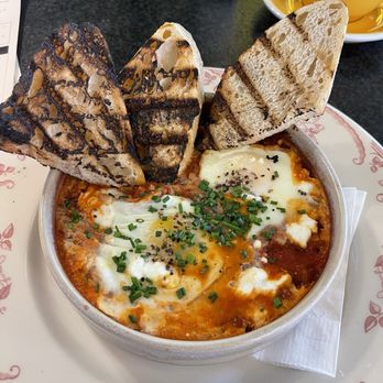 Crack'D Brunch - Shakshuka - eggs in spicy red marinara sauce with sourdough grilled. - Breakfast & Brunch Near Me - New Orleans, Louisiana Crack'D Brunch - Shakshuka - eggs in spicy red marinara sauce with sourdough grilled. - Breakfast & Brunch Near Me - New Orleans, Louisiana