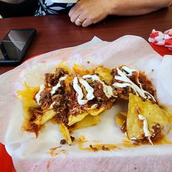 Nachos Grande ($8.19) with sour cream ($1.10) that we paid for. There were literally three nachos eaten out of the front center before pictu