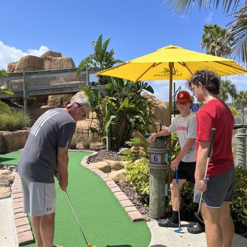 Lighthouse Cove Adventure Golf - three people playing miniature golf - Mini Golf Near Me - Cocoa Beach, Florida Lighthouse Cove Adventure Golf - three people playing miniature golf - Mini Golf Near Me - Cocoa Beach, Florida