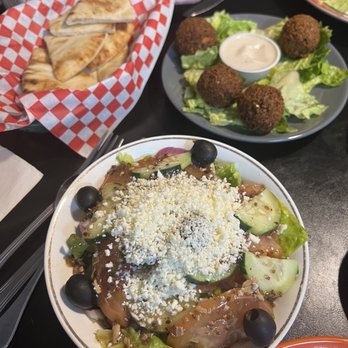 Kinzi - Greek salad (front dish) and falafel (back right dish). - Mediterranean Near Me - Mission, Kansas Kinzi - Greek salad (front dish) and falafel (back right dish). - Mediterranean Near Me - Mission, Kansas