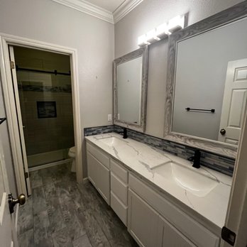 Compton Construction - a bathroom with two sinks and a shower - General Contractors Near Me