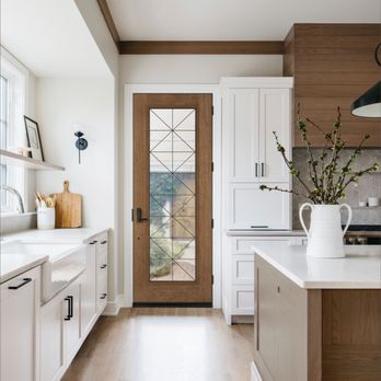 Builders FirstSource - Modern kitchen interior featuring a wood and glass exterior door with geometric grid design... - Building Supplies Near Me - Sedona, Arizona