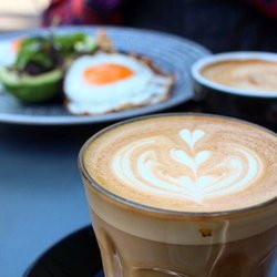 The Caffeine Laboratory - Vanilla latte (in front) and flat white, with eggs on toast and avocado with fresh greens! Yum!