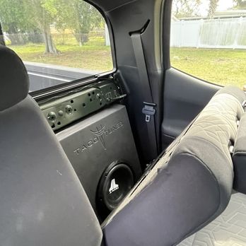 One Tribe Garage - 10" JL Audio subwoofer in custom enclosure behind driver side backseat - Car Stereo Installation Near Me One Tribe Garage - 10" JL Audio subwoofer in custom enclosure behind driver side backseat - Car Stereo Installation Near Me