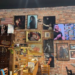 a brick wall with a variety of pictures on it a brick wall with a variety of pictures on it