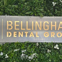 Bellingham Dental Group - The official Bellingham Dental Group sign displayed in front of a vibrant green wall inside the office...
