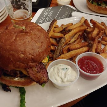 Art Marble 21 - AM21 Burger (peppered bacon with cheddar cheese, lettuce, red onion, tomato, and mayo) with fries. - Cocktail Bars Near Me - Seattle, Washington Art Marble 21 - AM21 Burger (peppered bacon with cheddar cheese, lettuce, red onion, tomato, and mayo) with fries. - Cocktail Bars Near Me - Seattle, Washington