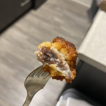 Round Table Pizza - a person holding a piece of pizza on a fork - Pizza Near Me - Fremont, California Round Table Pizza - a person holding a piece of pizza on a fork - Pizza Near Me - Fremont, California