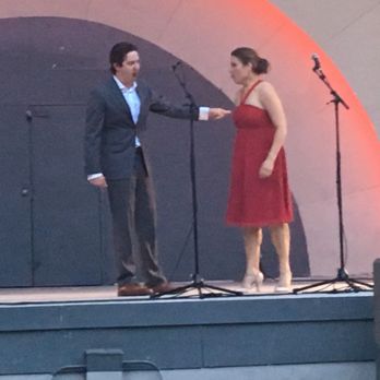 Boulder Band Shell - a man and woman shaking hands on stage - Music Venues Near Me Boulder Band Shell - a man and woman shaking hands on stage - Music Venues Near Me