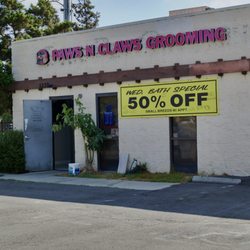 Paws n Claws Grooming - Front of building showing name and discount.