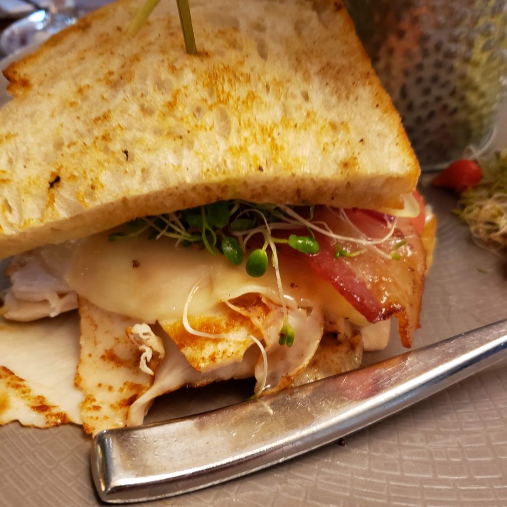 Sustenio - Half of the smoked turkey club sandwich - New American Near Me - San Antonio, Texas