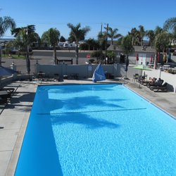 HOLIDAY RV PARK - View from the clubhouse of HRVP Pool, and beach just beyond the palm trees.