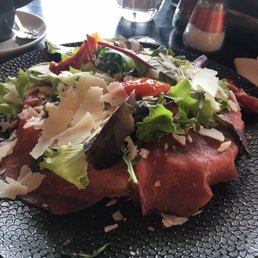 Carpaccio- a delicious open faced sandwich with thin slices of rare roast beef, arugula, cheese, pine nuts and pesto sauce.