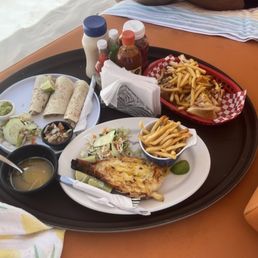 Lobster tail, fish tacos, and a sandwich.