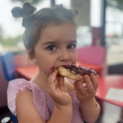 Loving her chocolate heart donut