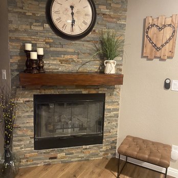 Valley Builders - Filled in the awkward cutout wall and added ledge stone and a mantle - General Contractors Near Me
