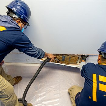 FIRST ONSITE Property Restoration - two construction workers working on a wall - Damage Restoration Near Me - Surrey, British Columbia