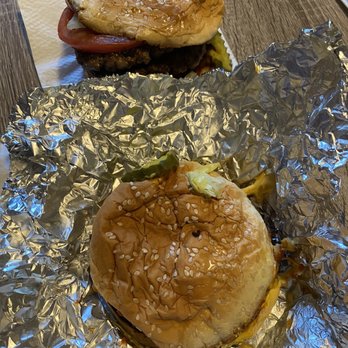 Five Guys - two hamburgers on tin foil on a table - Burgers Near Me - Rexburg, Idaho