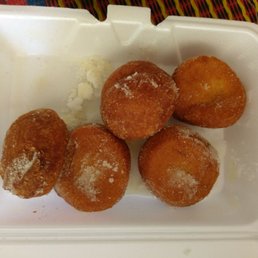 four doughnuts in a styrofoam container four doughnuts in a styrofoam container