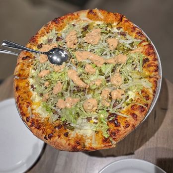 Alto - a pizza with cheese and lettuce on it - Sandwiches Near Me - Montreal, Quebec Alto - a pizza with cheese and lettuce on it - Sandwiches Near Me - Montreal, Quebec