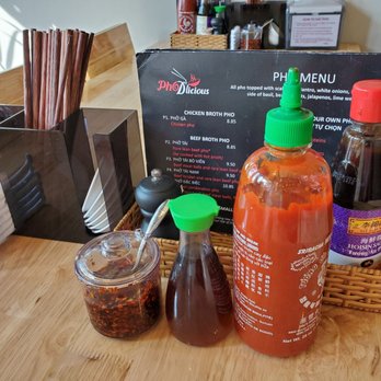 Pho D'licious - Asian condiments on the table, one of clues that tells you that this place may be serving an authentic Asian dish. - Vietnamese Near Me - Fargo, North Dakota