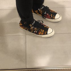 Undefeated - A customer wearing Converse Chuck Taylor All-Star 70s Ox Undefeated Varsity Jacket.