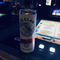 a can of clam beer on a bar