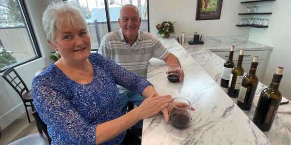 Meet The Owners - Melanie and John have a strong love of wine from living in California. They traveled extensively throughout the various wine regions in California – Santa Barbara, Paso Robles, Lodi, The Central Coast, Sonoma, Napa, Russian River Valley, Anderson Valley, Alexander Valley, and Mendocino County. From all of this, they dreamt of establishing a small boutique winery after retiring.

In 2019, John retired and they started searching for a place to launch their winery. While searching for a place to live, Melanie fell in love with the Treasure Valley, especially the Eagle area. And so, John and Melanie settled down in Eagle and began their new life as growers and winemakers.