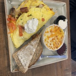 The works omelette and grits with cheese The works omelette and grits with cheese