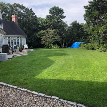 Four Paws Lawn Care - a lawn with a blue tarp - Lawn Services Near Me - Mashpee, Massachusetts Four Paws Lawn Care - a lawn with a blue tarp - Lawn Services Near Me - Mashpee, Massachusetts