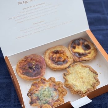 Na Tart - Top left to right: ube cheese, original Portuguese tarts x 2, Bottom: cheese and corn, soy milk and black rice - Desserts Near Me - New York, New York Na Tart - Top left to right: ube cheese, original Portuguese tarts x 2, Bottom: cheese and corn, soy milk and black rice - Desserts Near Me - New York, New York