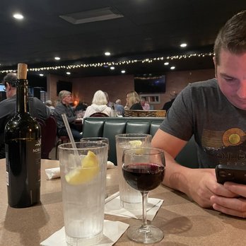 Murphy's Steakhouse - a man looking at his phone - Steakhouses Near Me - Indianapolis, Indiana