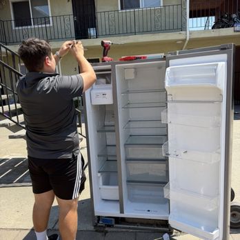 Nice Fellows Moving - A people working to take off the refrigerator door - Movers Near Me - Santa Clara, California