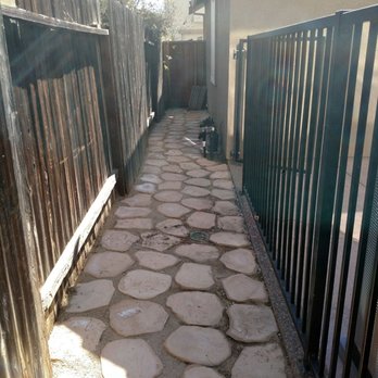 Master Pavers and Landscaping - dog runner area behind iron gate - Landscaping Near Me