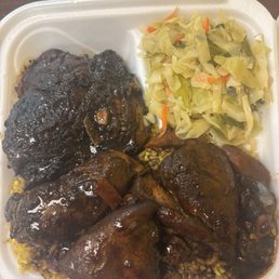 Jerk chicken and chicken & brown sauce with spicy rice and cabbage. Jerk chicken and chicken & brown sauce with spicy rice and cabbage.