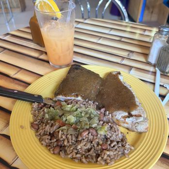 The Little Grill - Wood-Grilled Chicken Leg served with Jerk Sauce and a side of Red Beans and Rice. - Caribbean Near Me - Manhattan, Kansas The Little Grill - Wood-Grilled Chicken Leg served with Jerk Sauce and a side of Red Beans and Rice. - Caribbean Near Me - Manhattan, Kansas