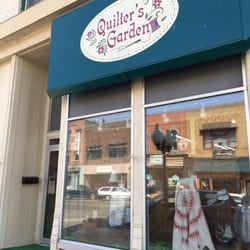Quilter's Garden - Out front of store....do not be deceived by dated old window front. It opens up into bright, tall ceilings, welcoming staff.